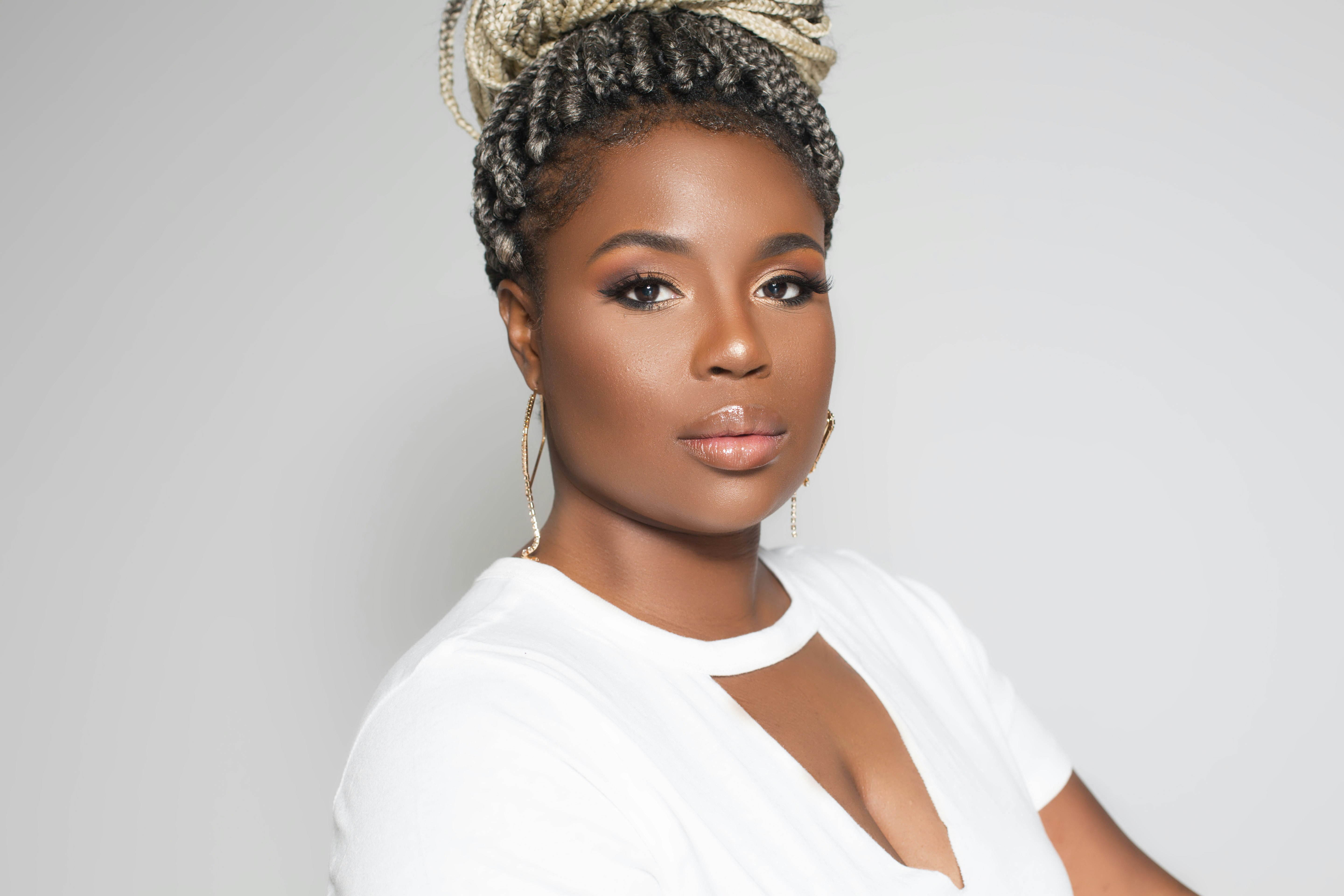 woman in white sleeveless shirt wearing gold crown